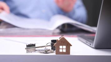 Real estate agent working with documents and house keys on desk video