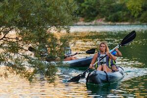 A group of friends enjoying having fun and kayaking while exploring the calm river, surrounding forest and large natural river canyons photo
