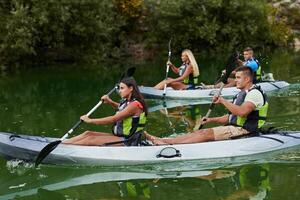 A group of friends enjoying having fun and kayaking while exploring the calm river, surrounding forest and large natural river canyons photo