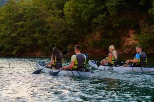 A group of friends enjoying having fun and kayaking while exploring the calm river, surrounding forest and large natural river canyons photo