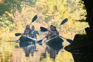 A group of friends enjoying having fun and kayaking while exploring the calm river, surrounding forest and large natural river canyons photo