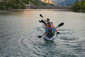A group of friends enjoying having fun and kayaking while exploring the calm river, surrounding forest and large natural river canyons photo