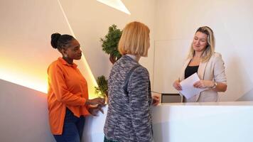 Engaging conversation at the reception desk in a modern office setting video