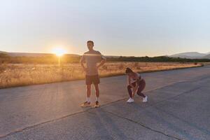 A couple resting after a rigorous morning run, embracing the tranquility of their surroundings as they find rejuvenation, fulfillment, and a deep sense of contentment in each other's company photo