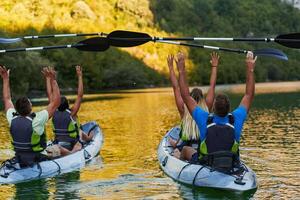 A group of friends enjoying having fun and kayaking while exploring the calm river, surrounding forest and large natural river canyons photo