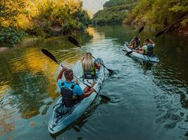 A group of friends enjoying having fun and kayaking while exploring the calm river, surrounding forest and large natural river canyons photo