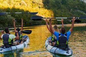 A group of friends enjoying having fun and kayaking while exploring the calm river, surrounding forest and large natural river canyons photo