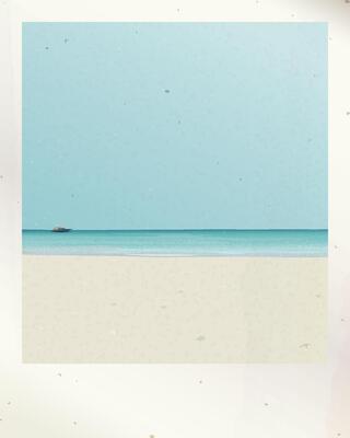 Old polaroid photograph of white sand beach and tropical blue sea have blue sky background with stained effect graphic illustration have blank space.