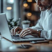 Man working on computer laptop at desk in office or home for business and technology concept use photo
