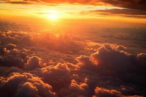 Golden sunset over clouds from airplane window capturing serenity and majesty photo