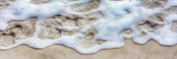 Aerial view of ocean waves crashing on sandy beach shoreline photo