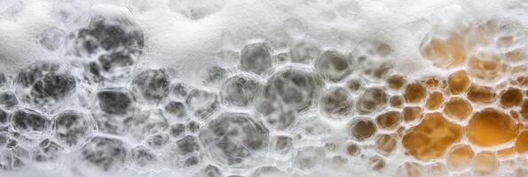 Close-up of soap bubbles with orange and gray color tones creating abstract patterns photo