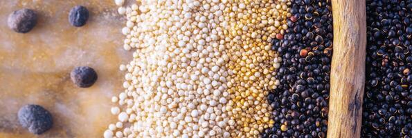 Variety of quinoa seeds including white, golden, and black grains in rustic display photo