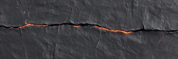 Cracked lava flow with glowing lava illuminating dark basalt surface photo