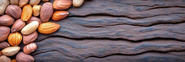 Assorted nuts on rustic wooden background displaying natural texture photo