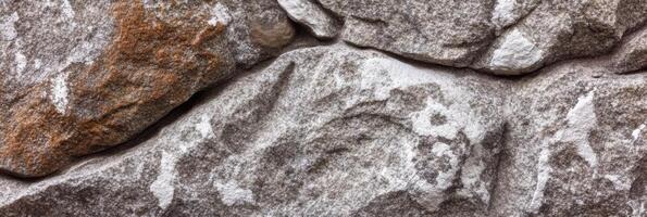 Close-up view of natural textured stone wall surface background photo