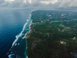 Panorama of coastline with ocean and waves on Green bowl beach in Bali. Aerial view photo