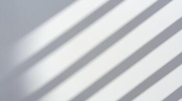 Diagonal Sunlight Shadows on White Wall creating a minimalist and calming pattern with soft gradients and subtle textures. photo