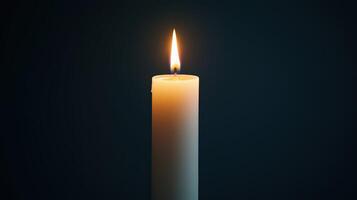 Single burning candle with a dark background. The warm glow of the flame creates a peaceful and reflective atmosphere, symbolizing hope, remembrance, spirituality, and solitude. photo