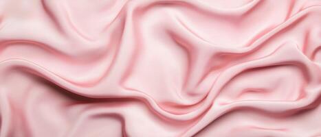 Soft pink silk fabric with elegant folds creating a smooth and luxurious texture. The gentle draping and subtle shadows enhance the delicate appearance of the textile. photo