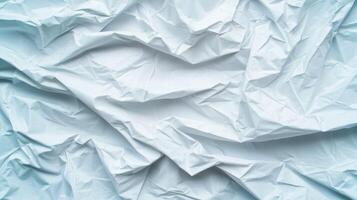 Wrinkled Light Blue Paper Texture Background with abstract folds and creases creating a dynamic and textured visual surface. photo