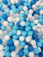 White and bright blue balls with a shiny and colorful pattern creates a textured background photo