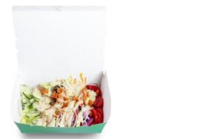 Fresh and colorful salad in a takeout box with a variety of vegetables. Copy space photo