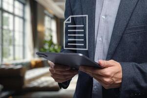 Businessman Checking Document on Tablet Modern Office Setting photo
