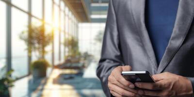 Businessman with Smartphone in Modern Office Environment photo