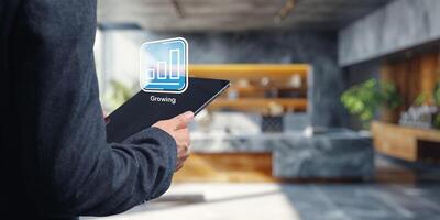 Growing Business Concept Icon on Tablet in Modern Home Kitchen photo