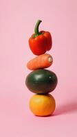 Stacked vegetables create a minimalist composition against a soft pink background emphasizing symmetry and color contrast photo