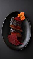 Slow-braised short rib with kombu mirin reduction and red algae tuile garnished with nasturtium dew for an elegant presentation photo