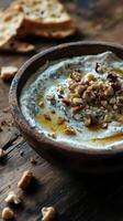 Rustic Gorgonzola dip served with nuts on a warm wooden surface photo