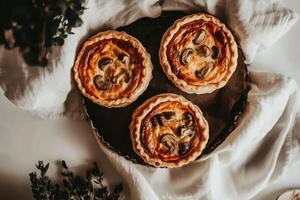 Mini chicken and mushroom quiches floating gracefully above a linen cloth in airy, soft lighting photo