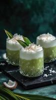 Luxurious pandan coconut milk tea served in diamond-cut glasses on a black quartz countertop photo