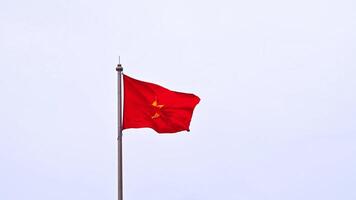 The Vietnamese flag flutters in the wind against a cloudy sky. Slow motion. A yellow star on a red background. video
