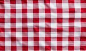 Red checkered tablecloth on a white background with contrasting red and white color pattern design photo