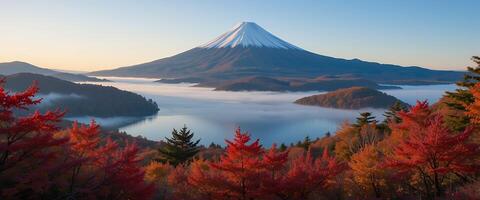 Mount Fuji's majestic peak viewed through a kaleidoscope of Autumn colors and misty lake photo