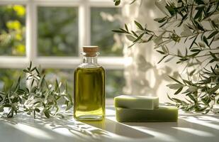 Olive oil bottle and green soap bars on white background photo