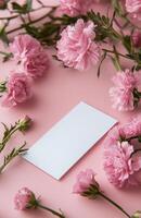 Blank White Gift Card Mockup with Pink Carnations on Pastel Pink Background photo