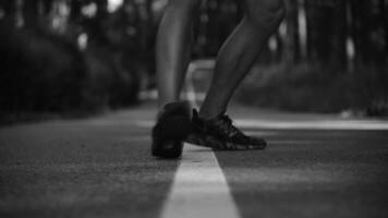 Close-up, running shoes, male runner getting ready for summer jogging in forest park. Jogging guy exercises for motivation, for health and fitness exercises video