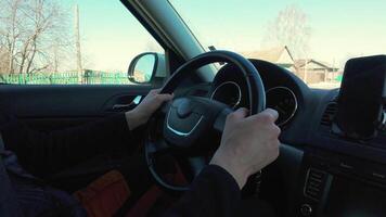 A man driving a car with his hands on the steering wheel video