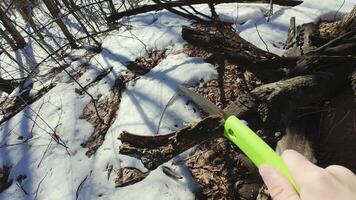 A person holding a green knife in the snow video