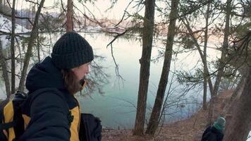 A person taking a selfie with a camera in the woods video