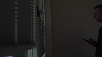 A close-up of window blinds casting shadows against a neutral wall, showcasing tranquility and light play. video