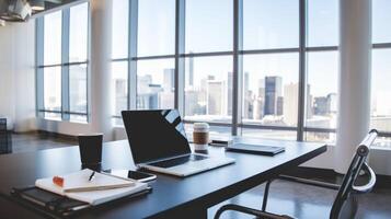 A laptop is sitting on a table in front of a window photo