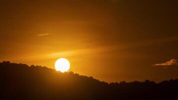The sun is setting behind a mountain range video