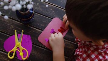Small child crafts greeting card for Mother's Day. video