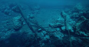 Underwater view in deep crystal lake with sunken wooden logs and stones. Most transparent Paisu pok lake in Indonesia. video