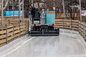 Ice resurfacing machine smoothing ice rink in Vienna photo
